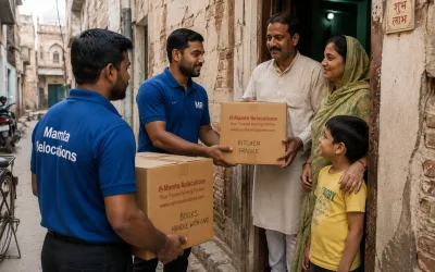 Movers handing labelled cartons to a family at a doorway in an old Allahabad mohalla lane — Mamta Relocations