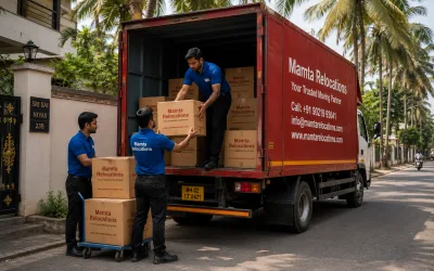 Movers loading labelled cartons on a Coimbatore residential street lined with coconut trees — Mamta Relocations