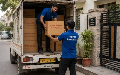 Movers stacking cartons into a tempo outside a Ghaziabad residential colony — Mamta Relocations