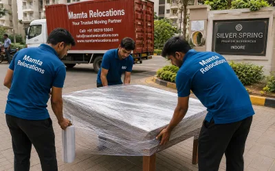 Movers wrapping a dining table outside an Indore residential colony — Mamta Relocations