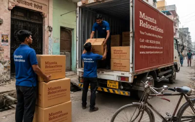 Movers loading cartons outside a Kanpur mohalla with a bicycle parked nearby — Mamta Relocations